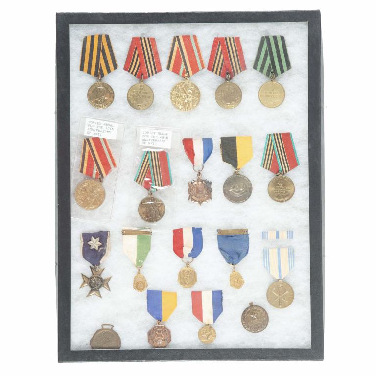 RIKER MOUNT OF SOVIET RUSSIA ANNIVERSARY MEDALS: RIKER MOUNT OF MOSTLY SOVIET RUSSIA ANNIVERSARY MEDALS. Lot also includes various awards for band, general scholarships, and etc.