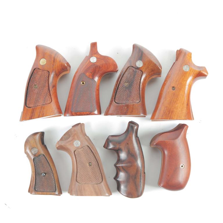 SIX SMITH AND WESSON N FRAME GRIPS AND TWO MISC.: SIX SMITH AND WESSON N FRAME GRIPS AND TWO MISC. GRIPS. American, 20th century. Six Smith and Wesson grips along with two smooth wood grips.