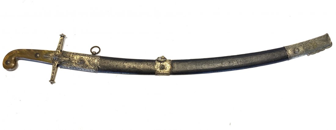 PERSIAN STYLE SCIMITAR: Late 19th century. Curved blade, crossbar guard and horn grips. Guard and white metal attachments on leather scabbard have chased foliate designs and raised faces. Wear and blade has ground areas. 35.