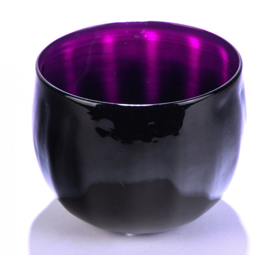 AMERICAN AMETHYST GLASS FINGER BOWL.: Second quarter 19th century. Fifteen ribs. Deep, almost black, amethyst. Small area of minor rim roughness, small open blister and some minor frit. 3.5"h. 4.5"d. Purchased 1964, Dr. Eller.