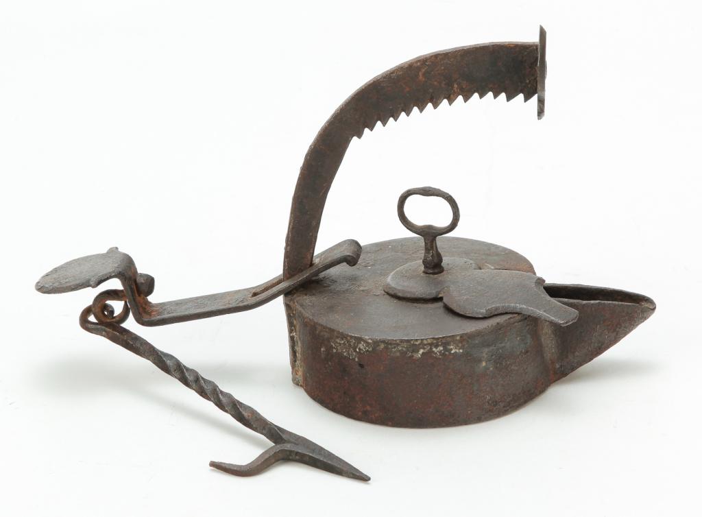 AMERICAN WROUGHT IRON BETTY LAMP.: First half 19th century. Swivel lid with key shaped finial and serrated hanger. 7"h. not including hook.
