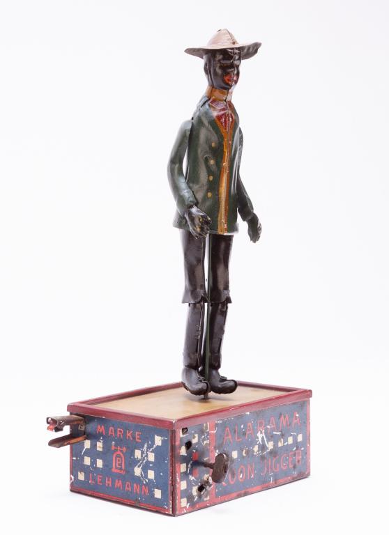 ALABAMA COON JIGGER MADE BY LEHMANN.: Germany, 2nd quarter-20th century. Lithographed tin die cast construction with platform base, spring wind, and in working condition, 10.5"h.