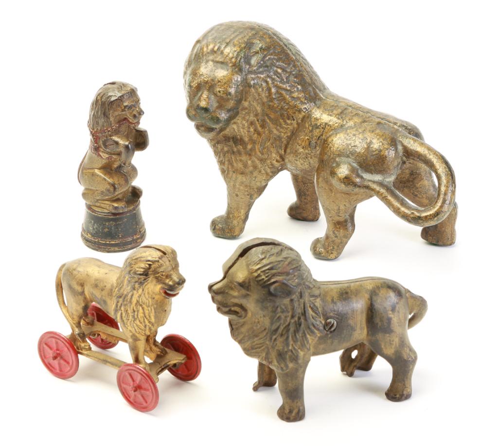 FOUR LION-THEMED STILL BANKS. (1 of 3)