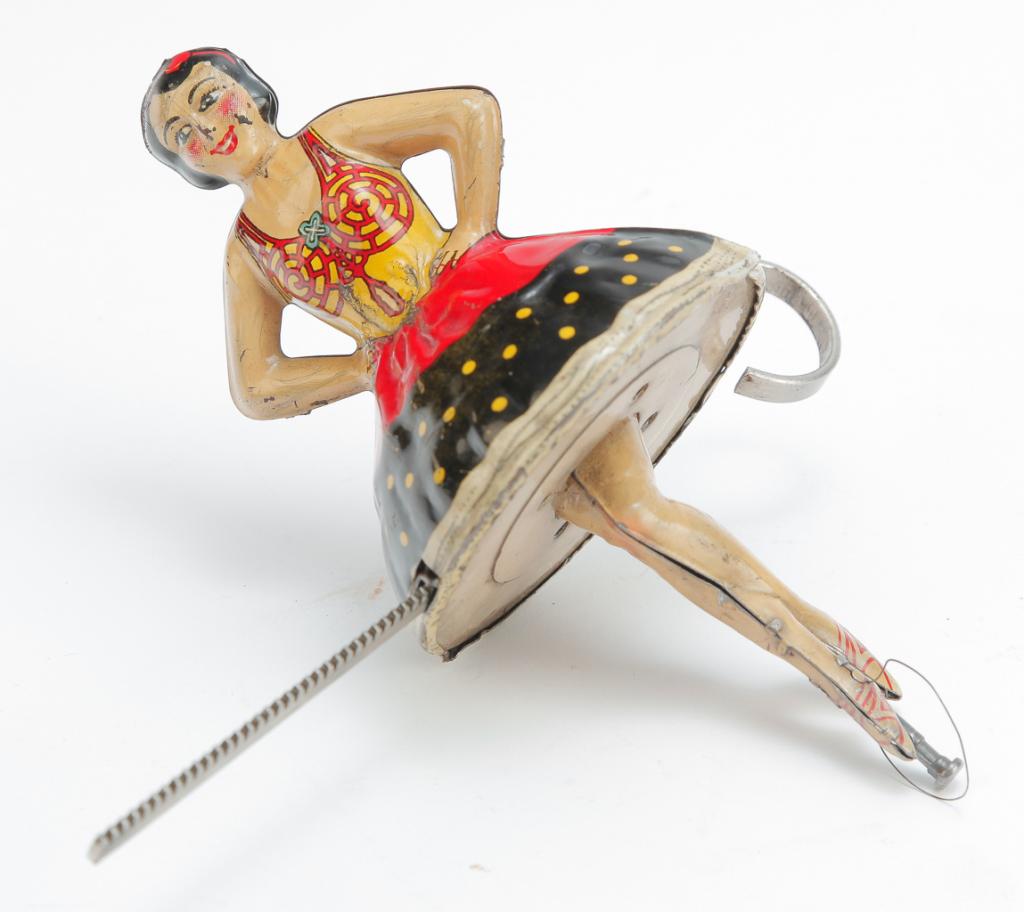 MARX SPINNING BELLERINA FRICTION TIN LITHO TOP: American, ca. 1930's. Colorful lithographed tin friction top in the form of a lady. Includes pull and functions properly. 6" tall.