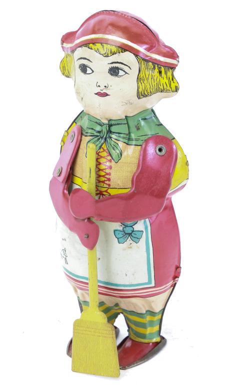 LINDSTROM TIN LITHO SWEEPING GRANNY WIND-UP TOY: American, 2nd quarter-20th century. Colorful lithographed tin figurine who sweeps when wound. Functions properly. 8" tall.