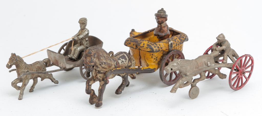 TWO CAST IRON HORSE DRAWN CARTS AND A SULKY (1 of 3)