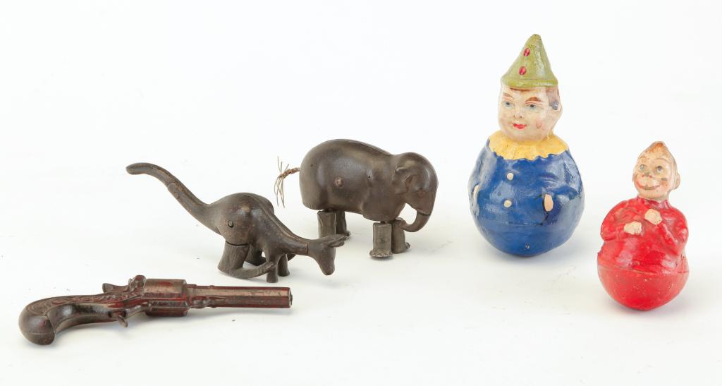 FIVE TOYS INCLUDING ROLY POLYS.: Probably American, early 20th century. Cast iron cap gun "Comet". Varnished surface, 5.5"l. and two cast iron animals with articulated legs. Elephant, 3.5"l. and kangaroo, 6". Together with two weight