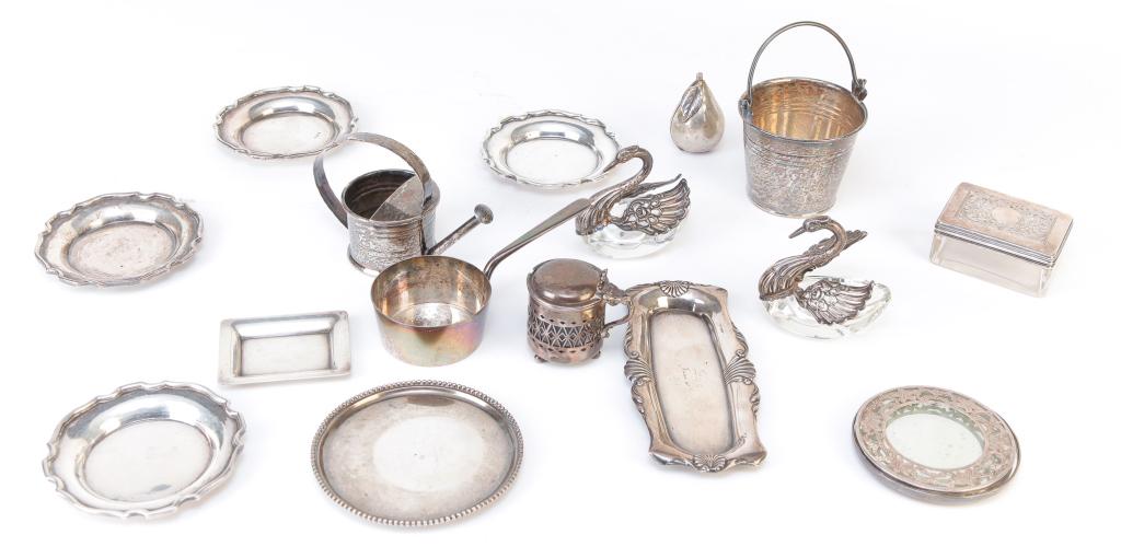 GROUP OF STERLING NOVELTY PIECES.: Nineteenth-20th century. Cartier watering can, pail, Birmingham 1913-1914 pan, round coaster with beaded edge, Kirk rectangular mini tray, Reed & Barton nail buffer tray dated 1891, glass jar with ret