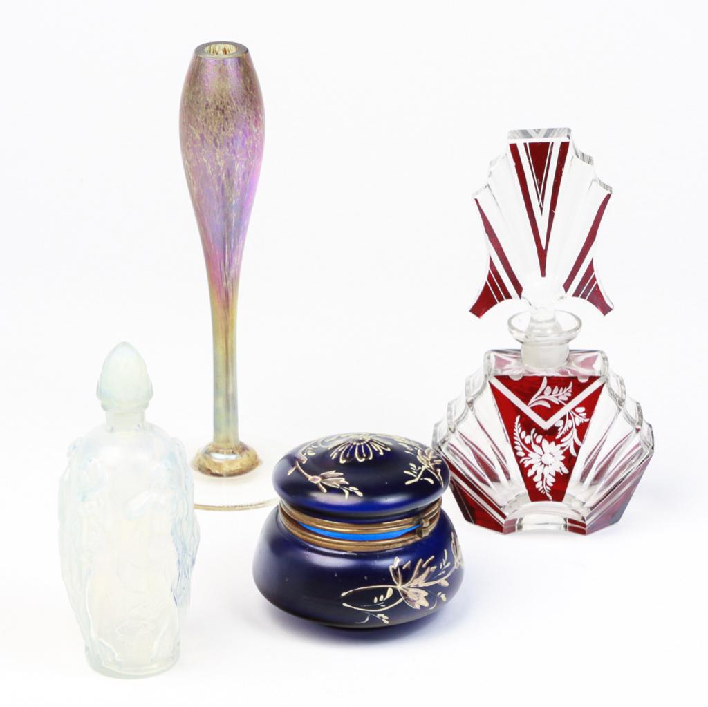 FOUR PIECES OF ART GLASS.: Twentieth century. Maslack iridized bud vase. Signed and dated on foot 10-73. 9"h., a Sabino opalescent perfume bottle with embossed female figures. Signed "Sabino, France", 6"h., a red cut to clear A