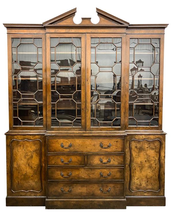 ENGLISH GEORGE III STYLE BREAKFRONT CABINET.: Mid 20th century, mahogany with oak secondary. Top with broken arch pediment, cornice with dentil row over carving, four doors with geometric patterned traceries, base with center drop front desk over