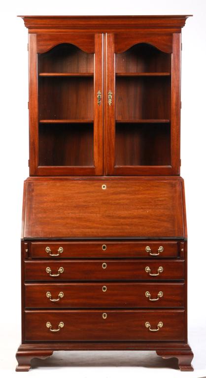 AMERICAN CHIPPENDALE STYLE SECRETARY BOOKCASE.: Made by Henkel Harris, late 20th century, mahogany with oak secondary. Top with cove molded cornice, two doors with beveled glass arched panes, base wtih slant front, four dovetailed overlapping drawe