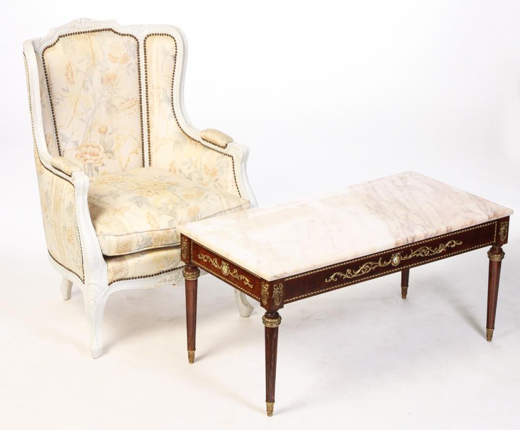 EUROPEAN FRENCH STYLE CHAIR AND TABLE.: Twentieth century. Louis XV style bergere, carved frame with faux marble finish, patterned upholstery with brass tack trim, 18" seat, 38.5"h. And a Louis XVI style coffee table. Pink marble top, frame