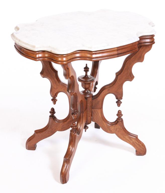 AMERICAN VICTORIAN MARBLE TOP PARLOR TABLE.: Third quarter 19th century, walnut. Veined white marble turtle top, base with scrolled legs, turned center column with urn finial and acorn finials and drops. 28"h. 29"w. 20.75"d.