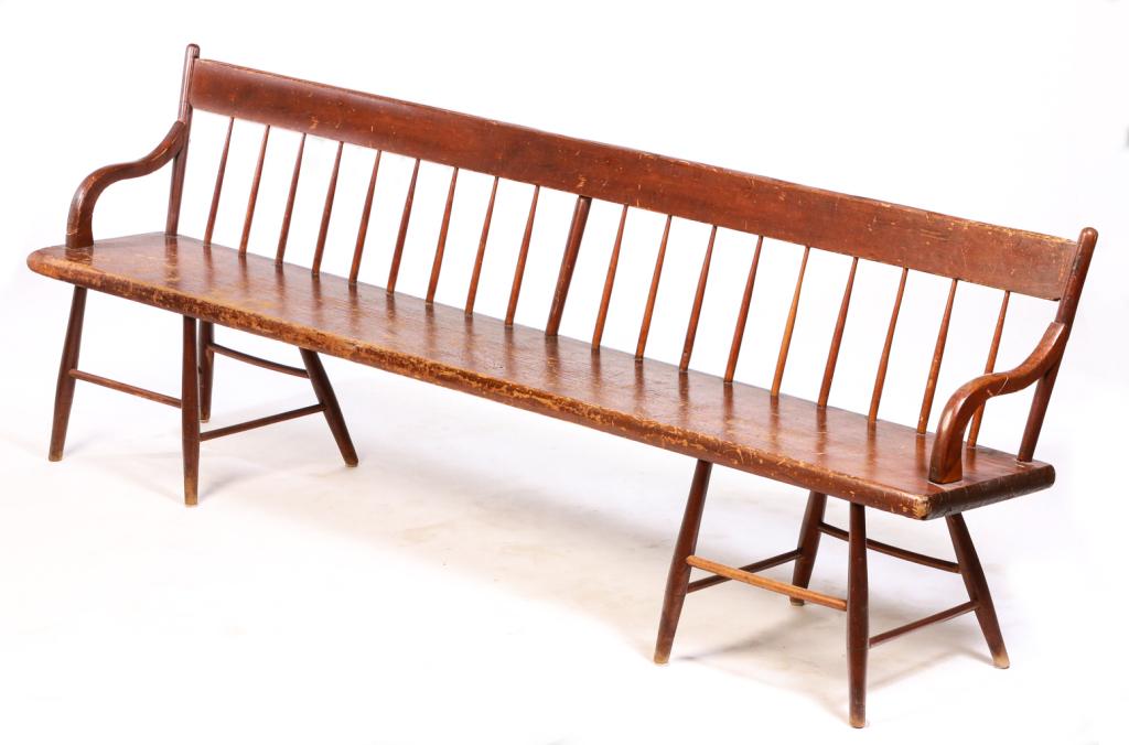 AMERICAN WINDSOR SETTLE BENCH.: Second quarter 19th century, pine and maple. Plain spindle back, curved arms, plank seat and chair base. Wear and repairs. 17" seat, 31.5"h. 89"w. 15.25"d.