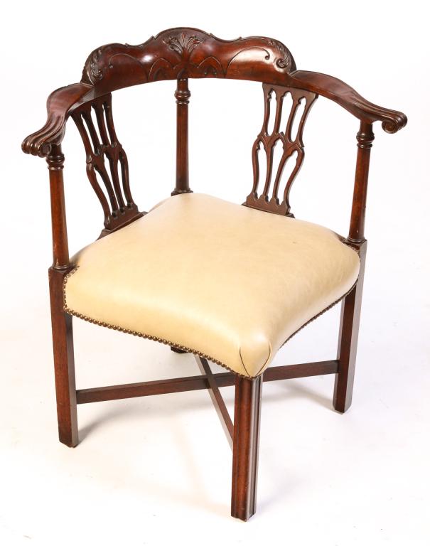AMERICAN CHIPPENDALE STYLE CORNER CHAIR.: Late 19th century, mahogany. Carved crest, knuckle arms, pierced splats, turned stiles, square legs, "X" stretcher and leather seat with brass tack decoration. 19" seat, 32.5"h.