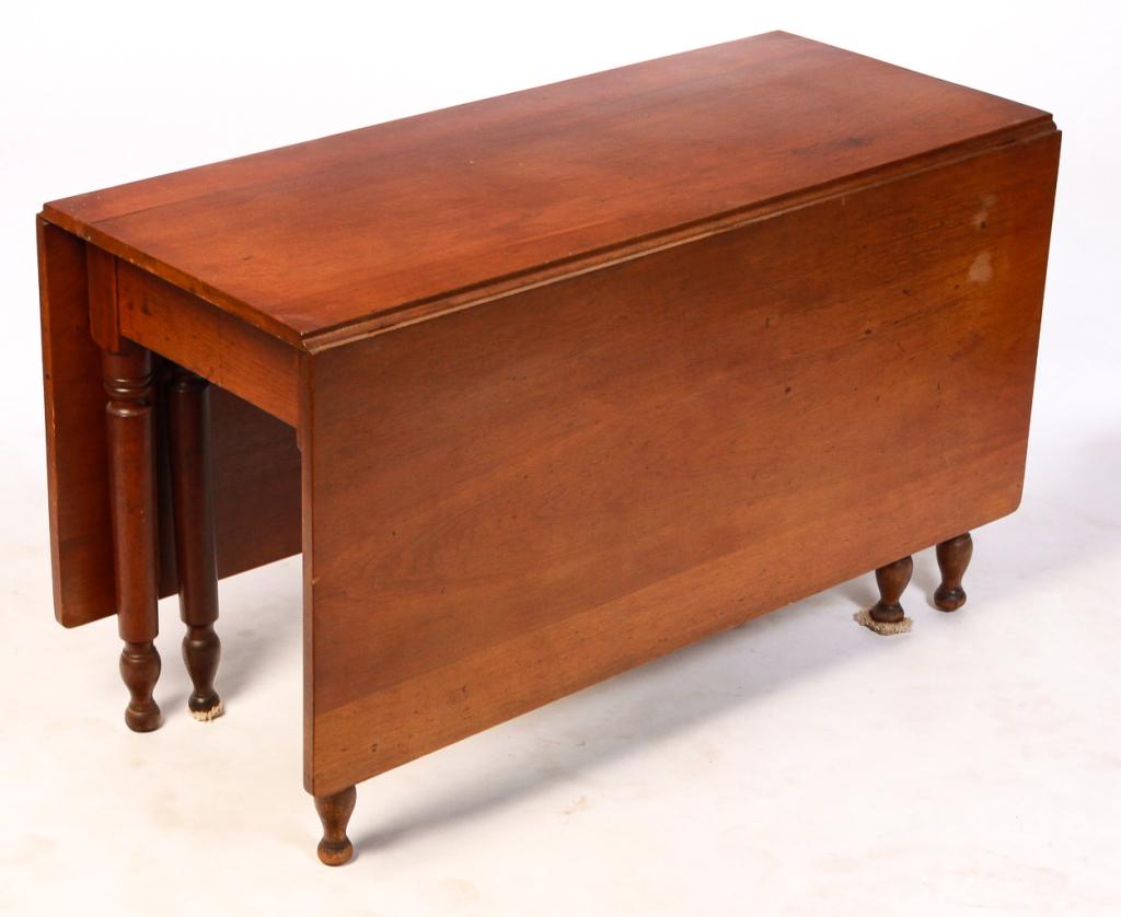 AMERICAN SHERATON DROP LEAF TABLE.: Second quarter 19th century, walnut. Turned legs with swing legs. 29"h. 49"w. opens to 64" with 22" leaves.
