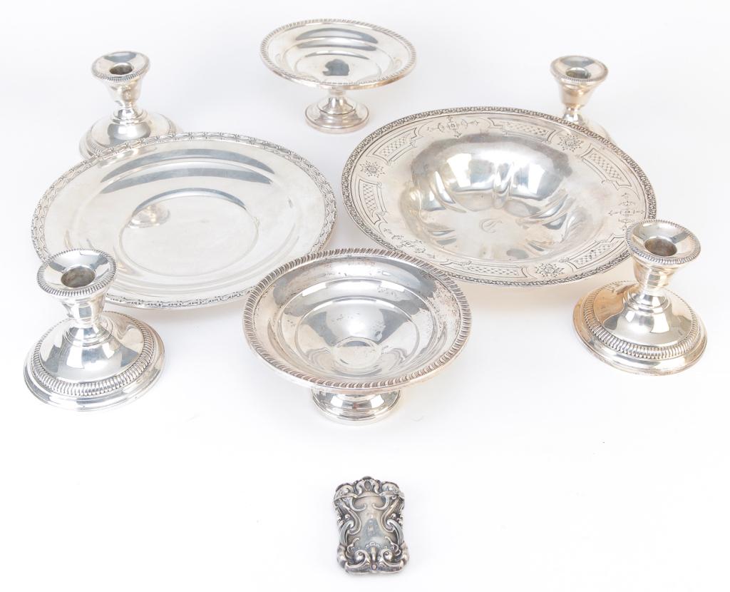 NINE PIECES OF AMERICAN STERLING SILVER.: Twentieth century. Dominick & Haff bowl with cast and pressed decoration, 1.75"h. 10"d., Gorham plate with pressed border 9.5"d., match safe with heavily embossed floral design, 2.25"h., four matching