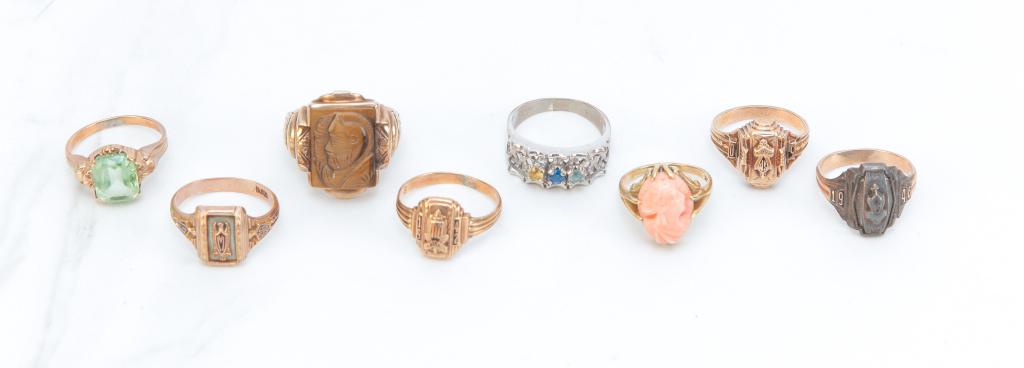 EIGHT VINTAGE GOLD RINGS.: American, mid-late 20th century. Eight rings including: 14K yellow gold carved coral cameo; 10K gents ring with carved tigers eye cameo; four 10K yellow gold class rings, 1940's; 10K ring with emerald