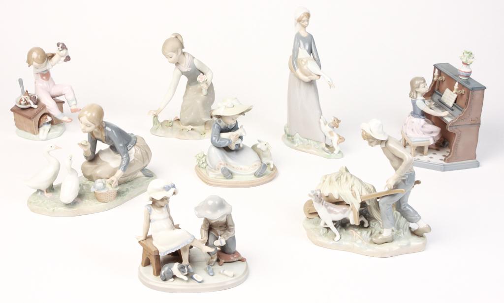 EIGHT SPANISH LLADRO FIGURINES.: Late 20th century. Girl at piano, 8.25"h. Girl feeding geese, 7"h. Girl with lambs, 6"h. Girl with puppies, 7.5"h. Girl picking flowers, 8"h. Girl with goose and puppy, 11"h. Boy with wagon and dog, 8