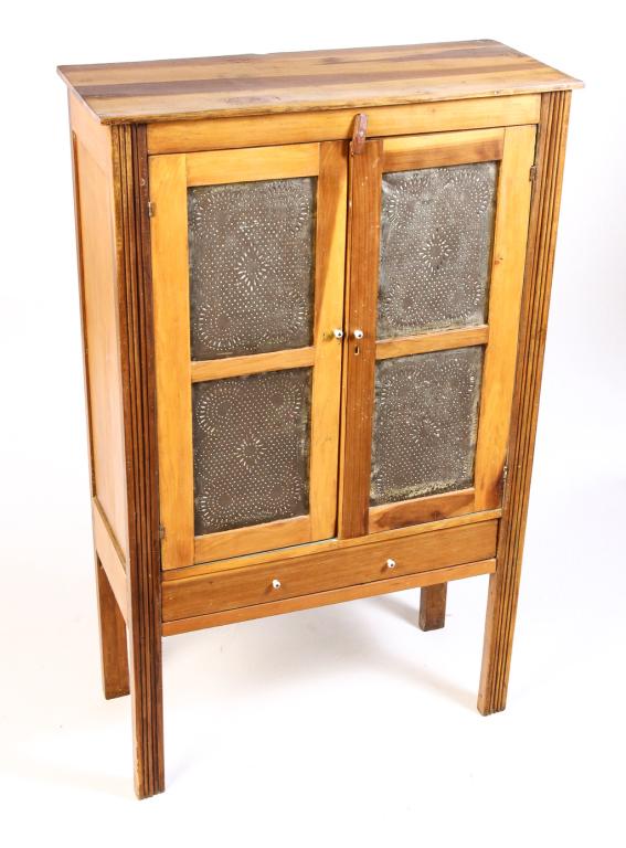 AMERICAN COUNTRY PIE SAFE.: Ca. 1900, poplar. Reeded stiles, paneled ends, two panel punched tin doors and lower drawer. Refinished. 56.75"h. 35"w. 14.5"d.