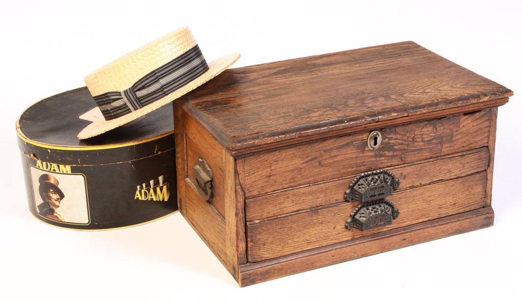 AMERICAN TOOL BOX AND STRAW BOATER.: Twentieth century. Oak box with lift lid and well and two lower drawers. Cast iron pulls and handles. 10.5"h. 21"w. 13"d. And a Pilgrim boater, size 7 1/4 in an "Adam" cardboard hat box.