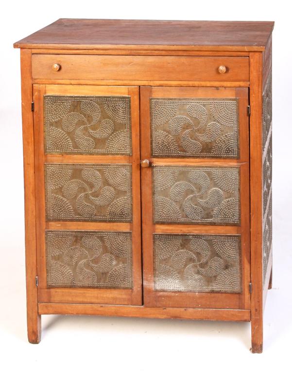 AMERICAN COUNTRY PIE SAFE.: Second half 19th century, poplar. Dovetailed top drawer, three punched tin panel ends and doors with pinwheel pattern. 51"h. 39"w. 16.75"d