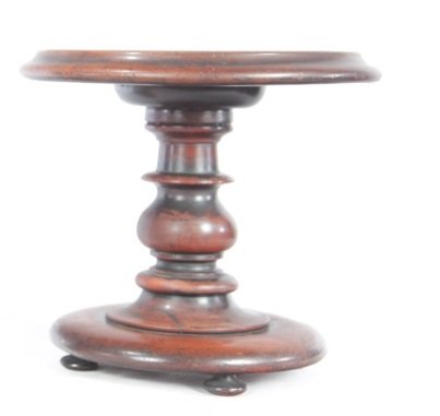 THREE ITEMS.: English and Canadian, 19th-20th century. Turned mahogany trivet. Repairs, 9.75"h. 11"d., and two "Phillips & Co., English Ginger Beer" stoneware bottles from Goderich, Ontario. Cracks. 7.75"h.