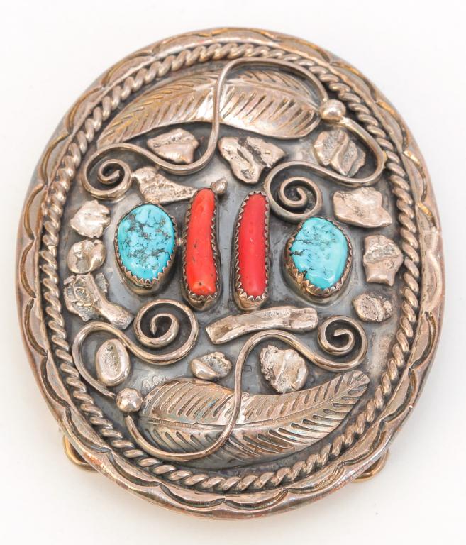 VINTAGE SILVER, TURQUOISE & CORAL NAVAJO BUCKLE.: American, late 20th century. Vintage oval silver belt buckle with turquoise and coral, raised silver leaf design signed J. Kee. Measures approx. 3.37" x 2.62", weight 76gr.