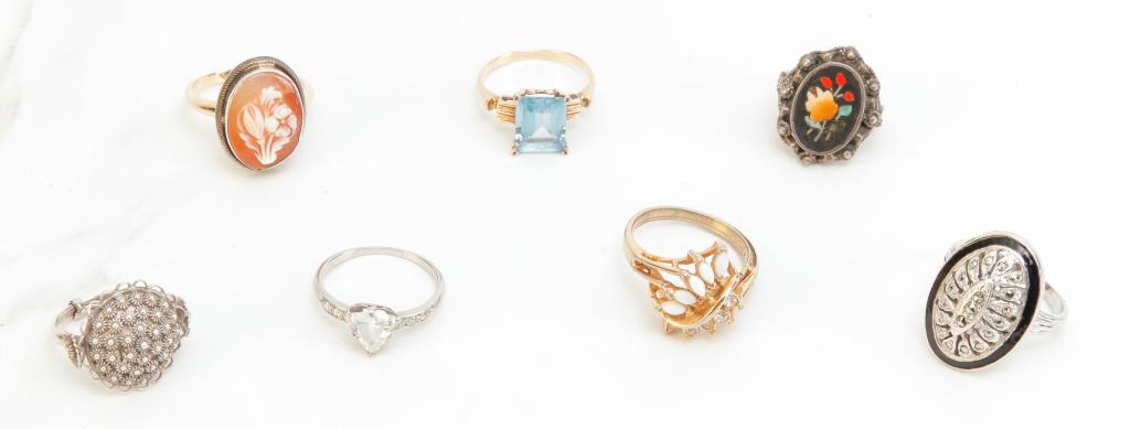 VINTAGE RINGS AND OTHER COSTUME JEWELRY.: Twentieth century. Group of assorted rings to include sterling with marcasites, floral cameo, mosaic, and more. Size 3 - 8. and mixed group of costume jewelry including pins, bracelets, earrings, clip