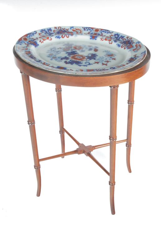 IRONSTONE PLATTER ON WIDDICOMB STAND.: Late 19th-1st half 20th century. Ironstone oval platter with Asian design marked "England". On a wooden bamboo stand labeled "John Widdicomb...Grand Rapids". 25"h. 18.5"w. 15"d. overall.