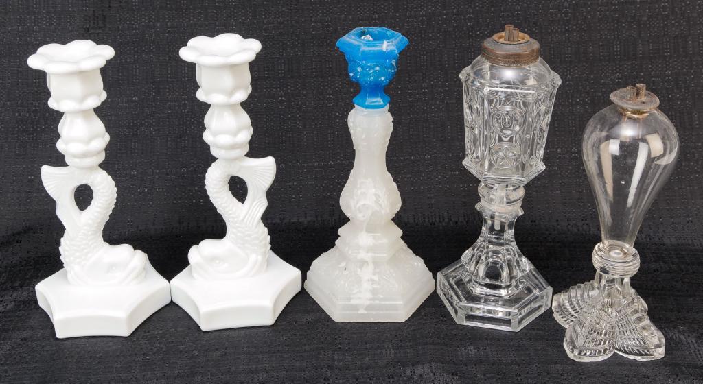 FIVE PIECES OF AMERICAN GLASS.: Three are mid 19th century flint. Two whale oil lamps. Blown font and pressed base, double burner. 9"h., Star & Prunty with double burner. Repairs, 10"h. and Sandwich Acanthus candlestick with clambro