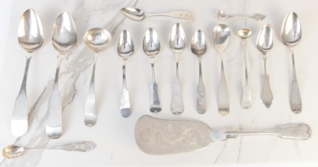 FIFTEEN PIECES AMERICAN SILVER.: Mid 19th century. Coin and sterling. Included are a serving piece by C. Stewart, Gorham salt spoon, three ladles (one with bright work), seven teaspoons (one with twist handle) and three tablespoons. 
