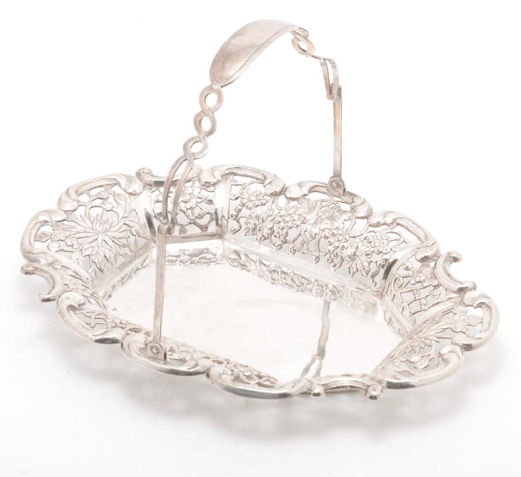 CHINESE EXPORT STERLING BASKET.: Late 19th-early 20th century. Hallmarked "Teh Ling & Co., Sterling 925". Reticulated floral basket with swing handle. 5.5"h. including handle. 9"l. Approx. 7 ozt.