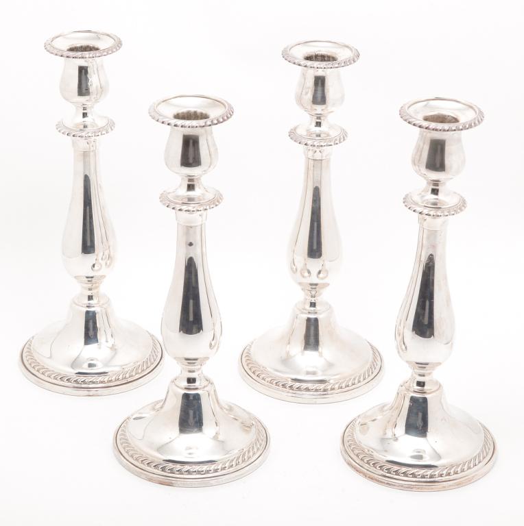 FOUR AMERICAN "GORHAM STERLING" CANDLESTICKS.: Mid 20th century. Matching with gadrooned edges and weighted bases. Removable bobeches. 10"h.