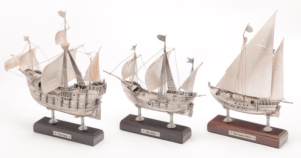 THREE SILVER COLUMBUS' SHIP MODELS.: Mid 20th century. "The Nina," "The Pinta," and "The Santa Maria." Detailed models all marked "925" on the keels as well as a copyright number "78." One wooden stand has broken supports. 6.75", 5.5", 7