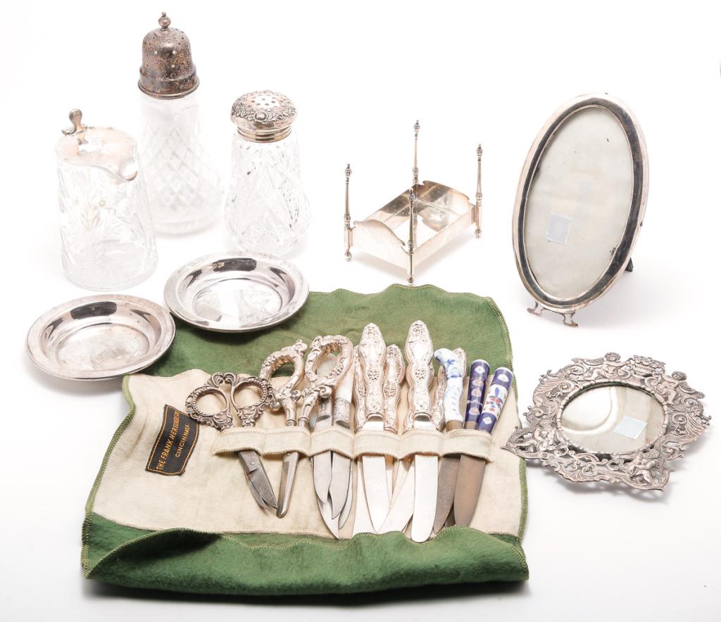 GROUP OF SILVER INCLUDING FRAMES AND FLATWARE.: Twentieth century. Cut glass syruper and shaker with "Sterling" lids. Dent. 4.5"h. And a cut glass muffineer with Birmingham, England 1965 silver lid, 7"h., "sterling" novelty bed, 3.25"h. 3.5"l., pai