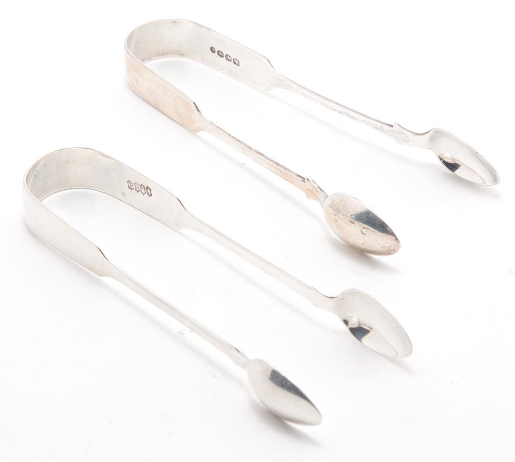 TWO ENGLISH AND IRISH SILVER SUGAR TONGS.: Exeter, England dated 1871, maker's mark "TS". And Dublin, Ireland dated 1825 by J. Buckton. Monogrammed. Approx. 2 ozt.