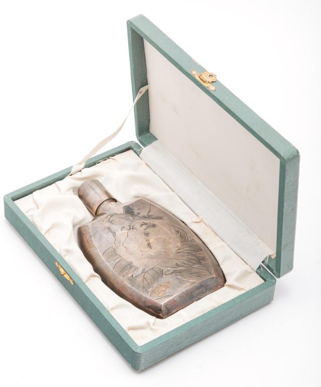 JAPANESE "SILVER" FLASK.: Early 20th century. Curved flask with engraved bird and flower and traces of coloring. Marked on the back and "Silver" on the bottom. Cork is stuck. 6"h. With fitted case.