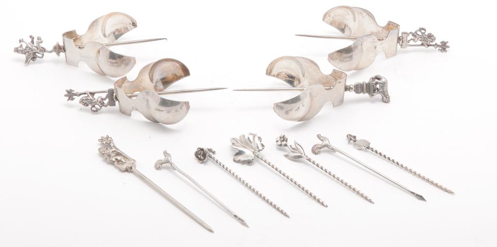 GROUP OF OLIVE SPEARS AND LEMON SQUEEZERS.: Twentieth century. Unmarked or illegible marks except for ones with finger tongs marked "800". 3" to 4"l.