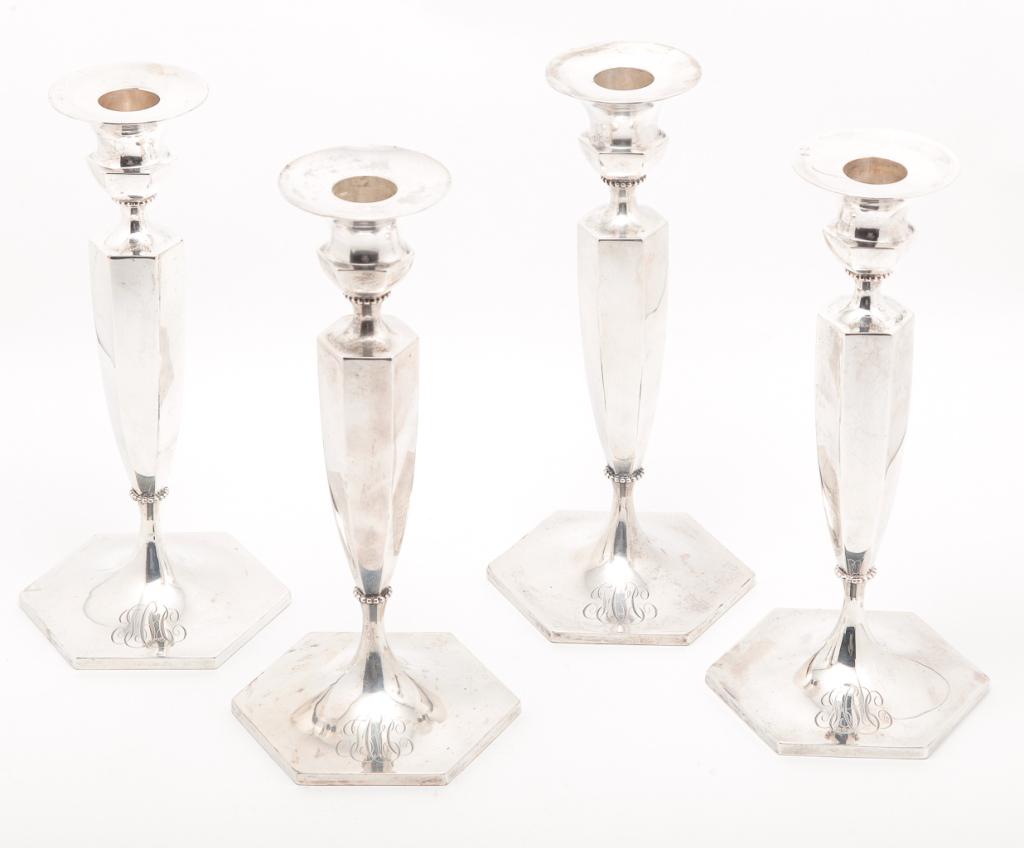 FOUR AMERICAN STERLING CANDLESTICKS.: Mid 20th century. Weighted with octagonal bases marked "Sterling" with flying eagle "trademark" and "Shreve, Crump & Lowe" retail mark. Monogrammed. 9.25"h.