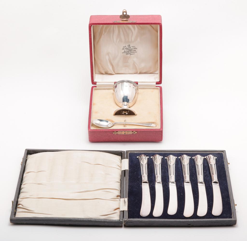 ENGLISH BOXED SILVER SALT AND KNIVES.: Birmingham salt and spoon with hallmarks for 1926 and 1927. Approx. 1.5ozt. Box marked "R. Stewart Ltd...Glasgow". And six Sheffield plate butter knives with monograms. Dated 1904.