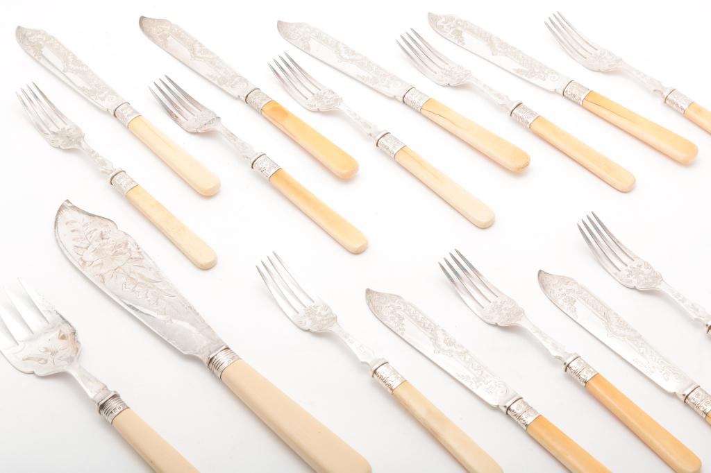 GROUP OF BRIGHTWORK SILVER PLATE FLATWARE.: American, late 19th century. Twelve matching forks and knives, blades marked "W&H SV". And an English Sheffield knife and fork with celluloid handle dated 1889 and 1890. 8.75", 11.5"l.