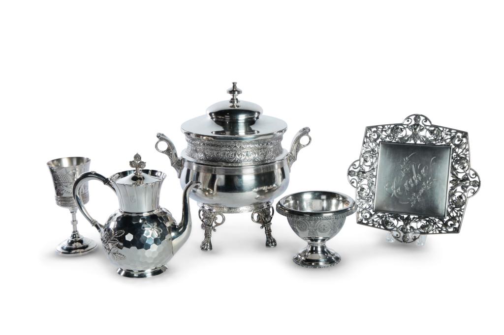 FIVE AESTHETIC PERIOD SILVERPLATED PIECES.: American, 4th quarter 19th century. Derby footed tureen with floral and geometric band, handles with rosettes, and floral and paw feet. 13"h. a Meriden coffee pot with fluted neck and faux-hammered bo
