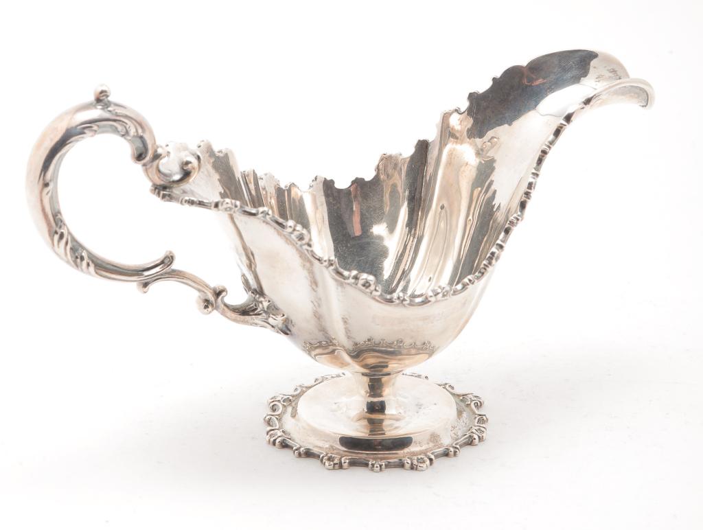 AMERICAN STARR STERLING SAUCE BOAT.: New York City, late 19th-early 20th century. Cast floral rim and foot. Marked on the bottom "Theodore B. Starr, Sterling". 4.25"h. 7.25"l. Approx. 5.6 ozt.