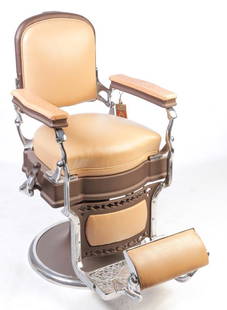 AMERICAN KOKEN BARBER CHAIR.: Ca. 1920. Hydraulic. Completely restored with faun leather seat and back with tooled arms, nickle plated hardware. Leather pieces for missing head rest included. 25" seat, 44.5"h.