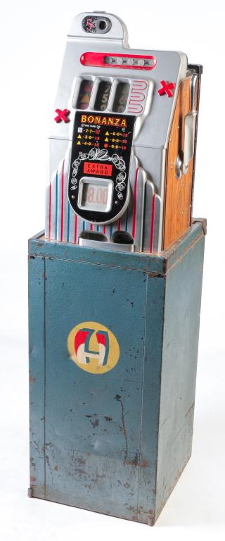AMERICAN "BONANZA" SLOT MACHINE.: First half 20th century. Metal with original paint and faux wood panel sides. Five cent slot machine attached to a base. Wear and scratches. Back panel has key. 57.5"h. 16.25"w. 17"d. overall.