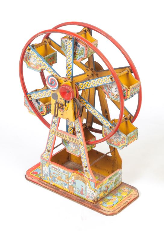 AMERICAN DISNEYLAND FERRIS WHEEL.: Mid 20th century, lithographed tin. Spring wind toy with Mickey Mouse and Donald Duck, Walt Disney Production. Some rust on base. 16.5"h. 11"w. 5"d.