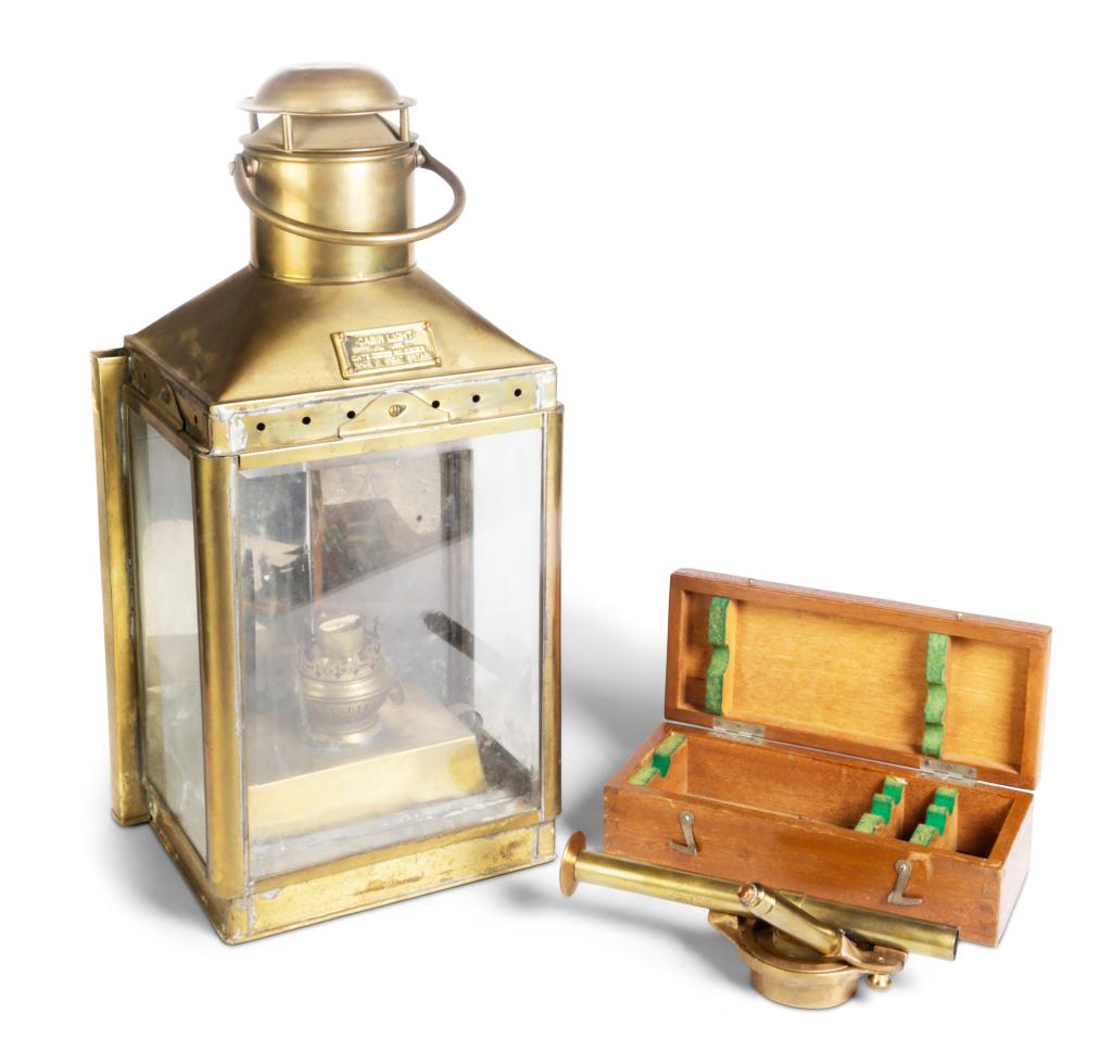 BRASS SHIP LANTERN AND BEARING SCOPE.: Twentieth century. Beveled edge glass sided lantern with oil font "Cabin Lght (oil use), Date 18-2-1965, No. 424, Made in Great Britain". 19.5"h. And a "Lafayette Bearing Scope, Model F-660, Japan". I