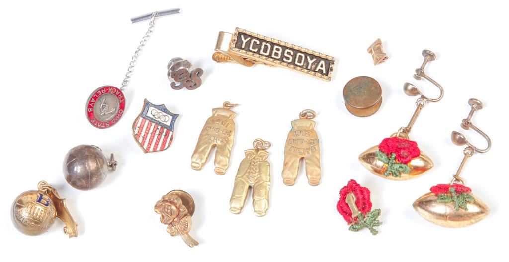THREE OSU BUCKEYES "GOLD PANTS" CHARMS & MORE.: 20th century. Three pairs of desirable "gold pants", Ohio State over Michigan 1960,61, 62. Each pair engraved "GS" on the knee pads (George Staten, athletic ticket director). Together with misc. sport