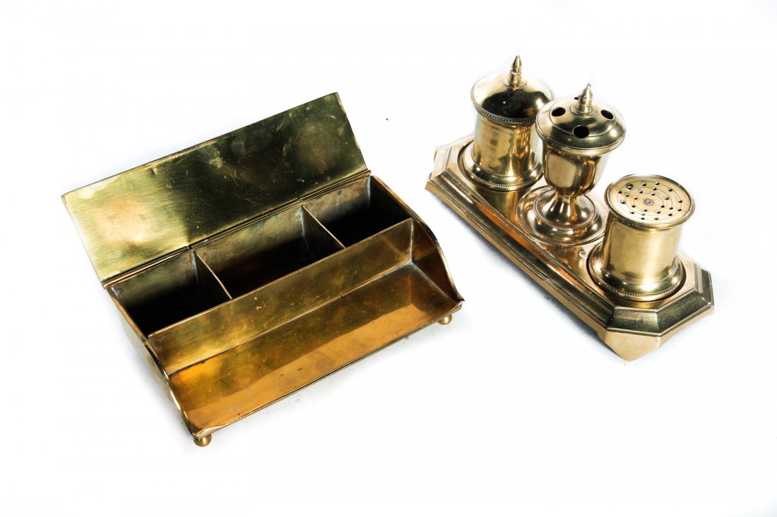 TWO ENGLISH BRASS DESK SETS.: Late 18th-mid 19th century. Cast desk set with removable ink (no insert), quill holder and sander. 5.5"h. 9"l. And sheet brass set with pen holder and fitted interior. Stamped "BGH". 2.25"h. 7.25"l.